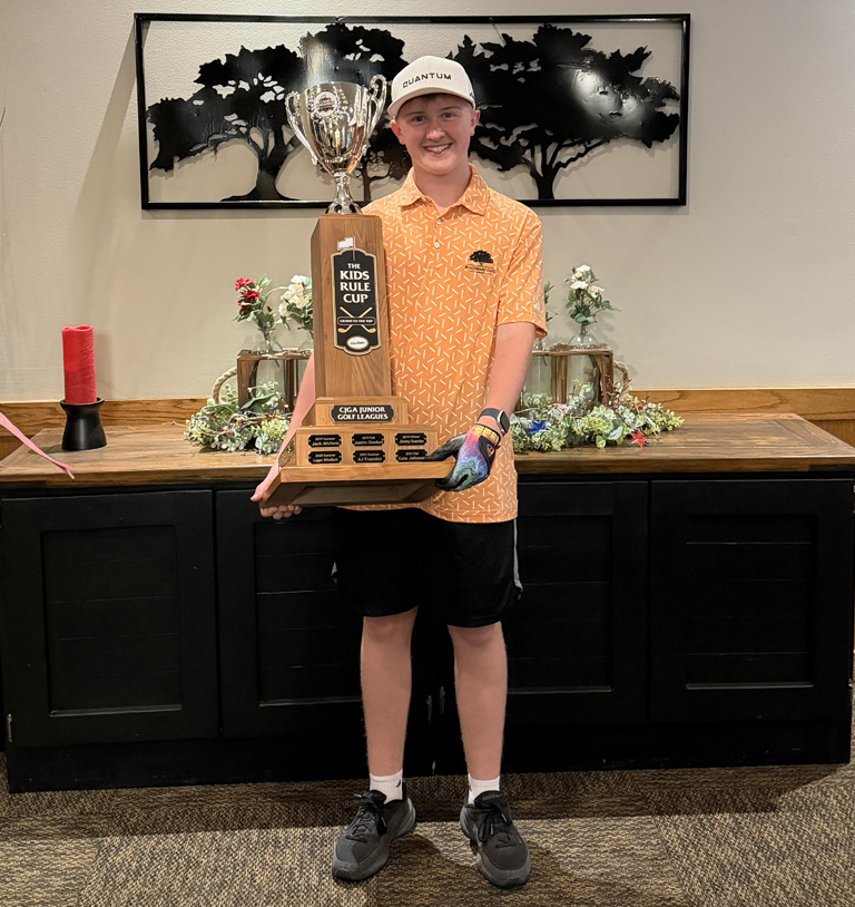 Young golfer holding large trophy